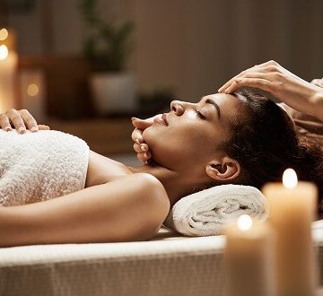 attractive-african-woman-enjoying-face-massage-spa-salon